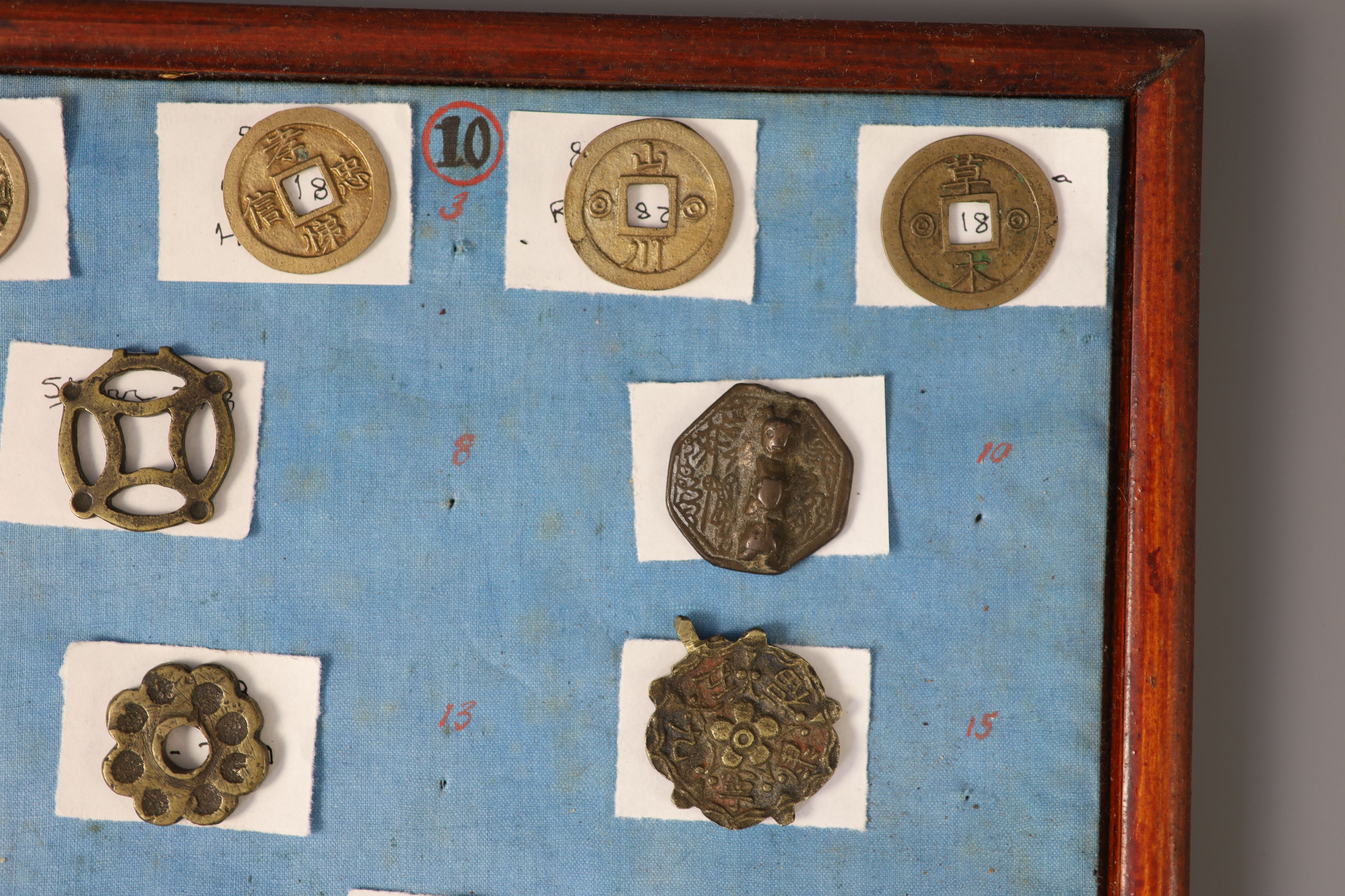A group of 99 Korean bronze and metal amulets or charms, 19th/20th century